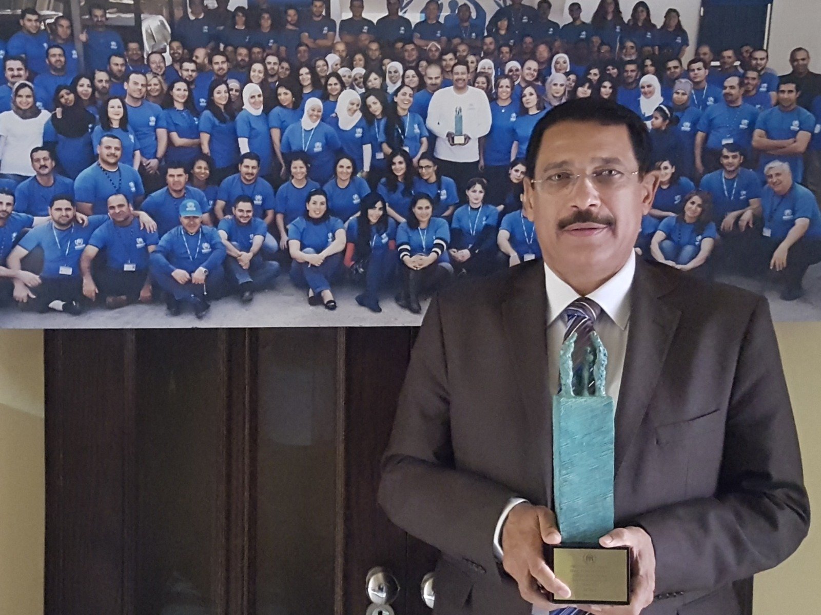 Recognised for distinguished service, pictured before a photograph of the country team.