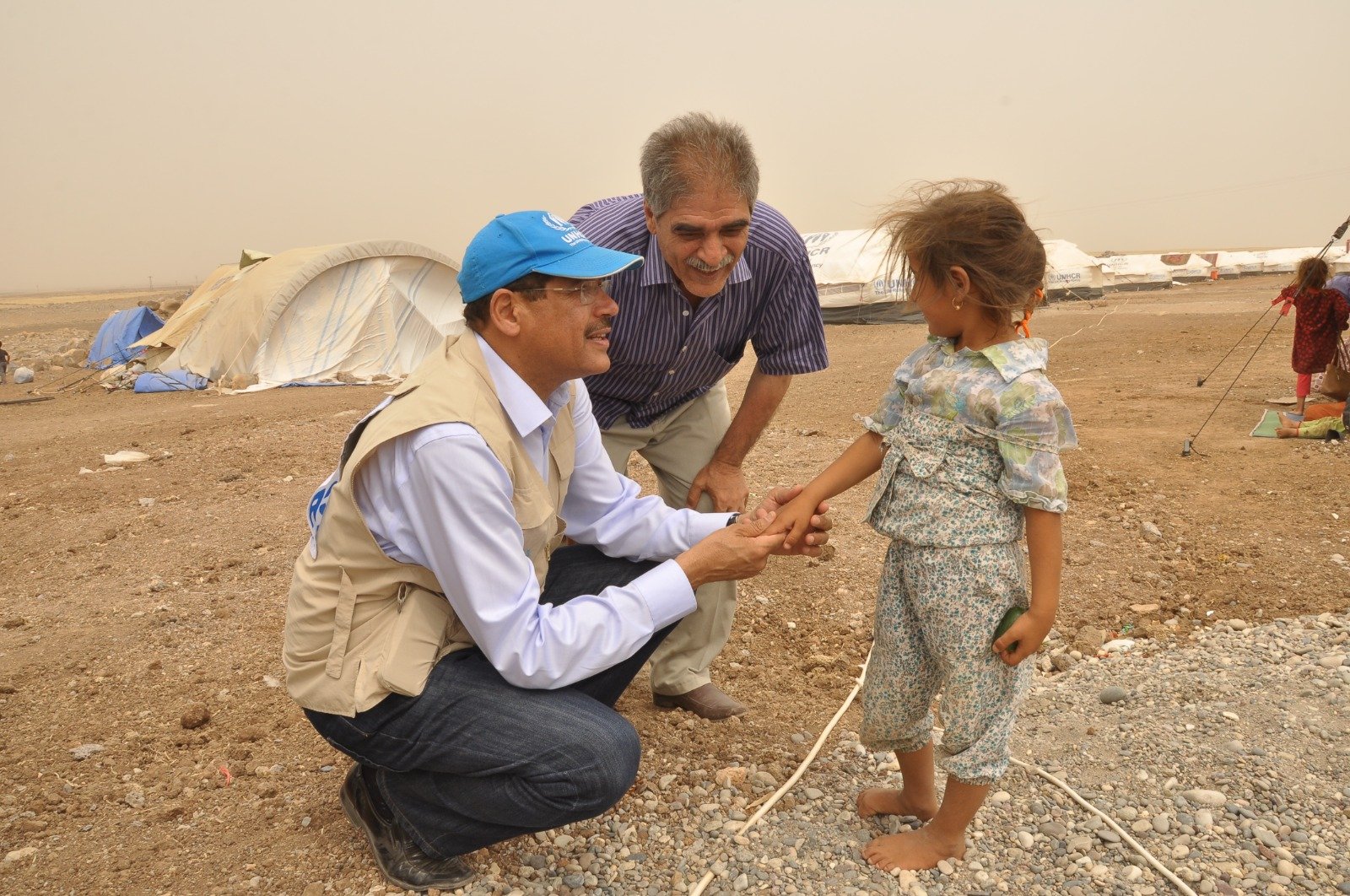 Greeting a young resident of a displacement camp during a field mission.