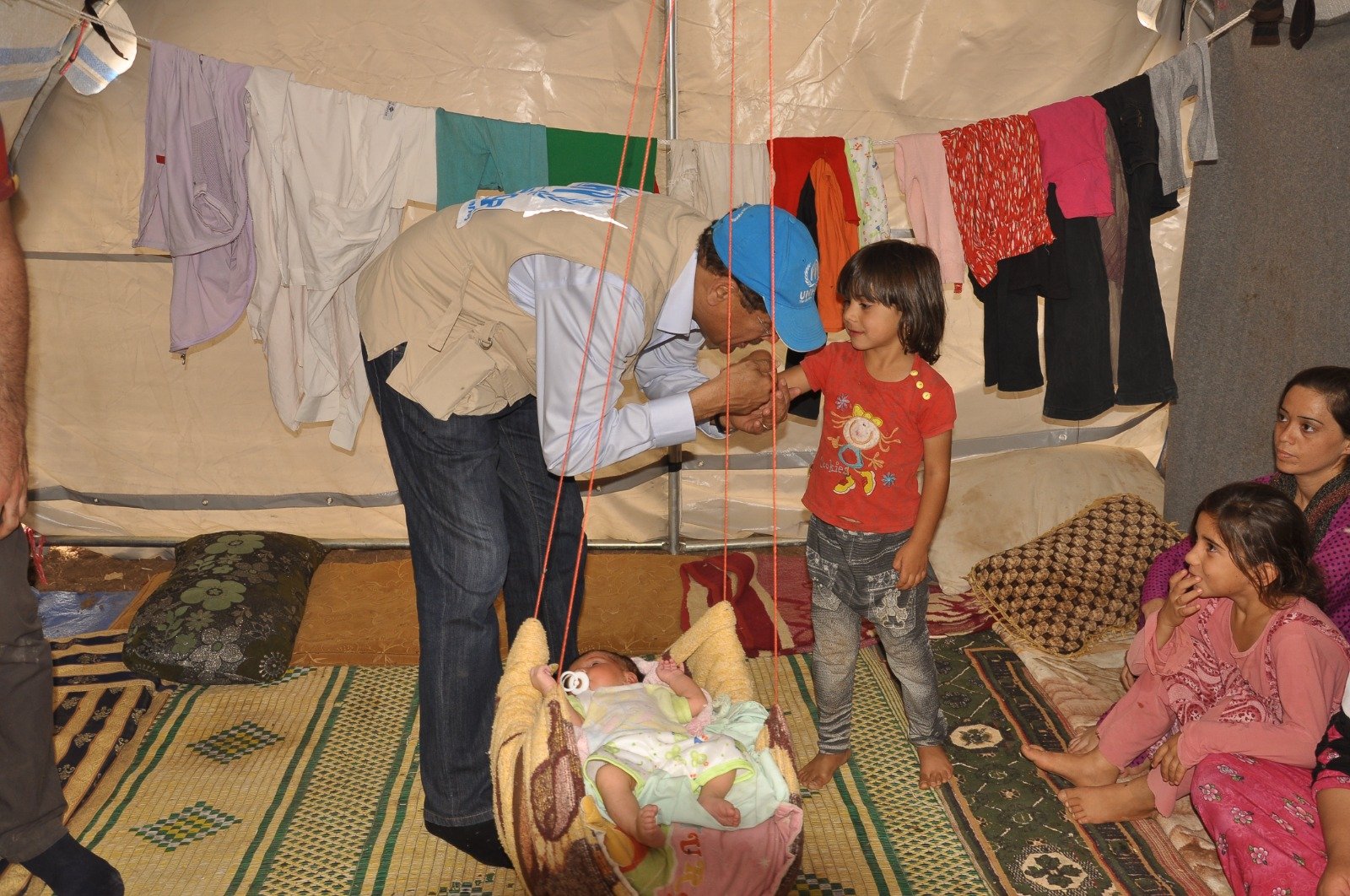 A home visit inside a displaced family’s shelter, meeting the youngest members of the household.