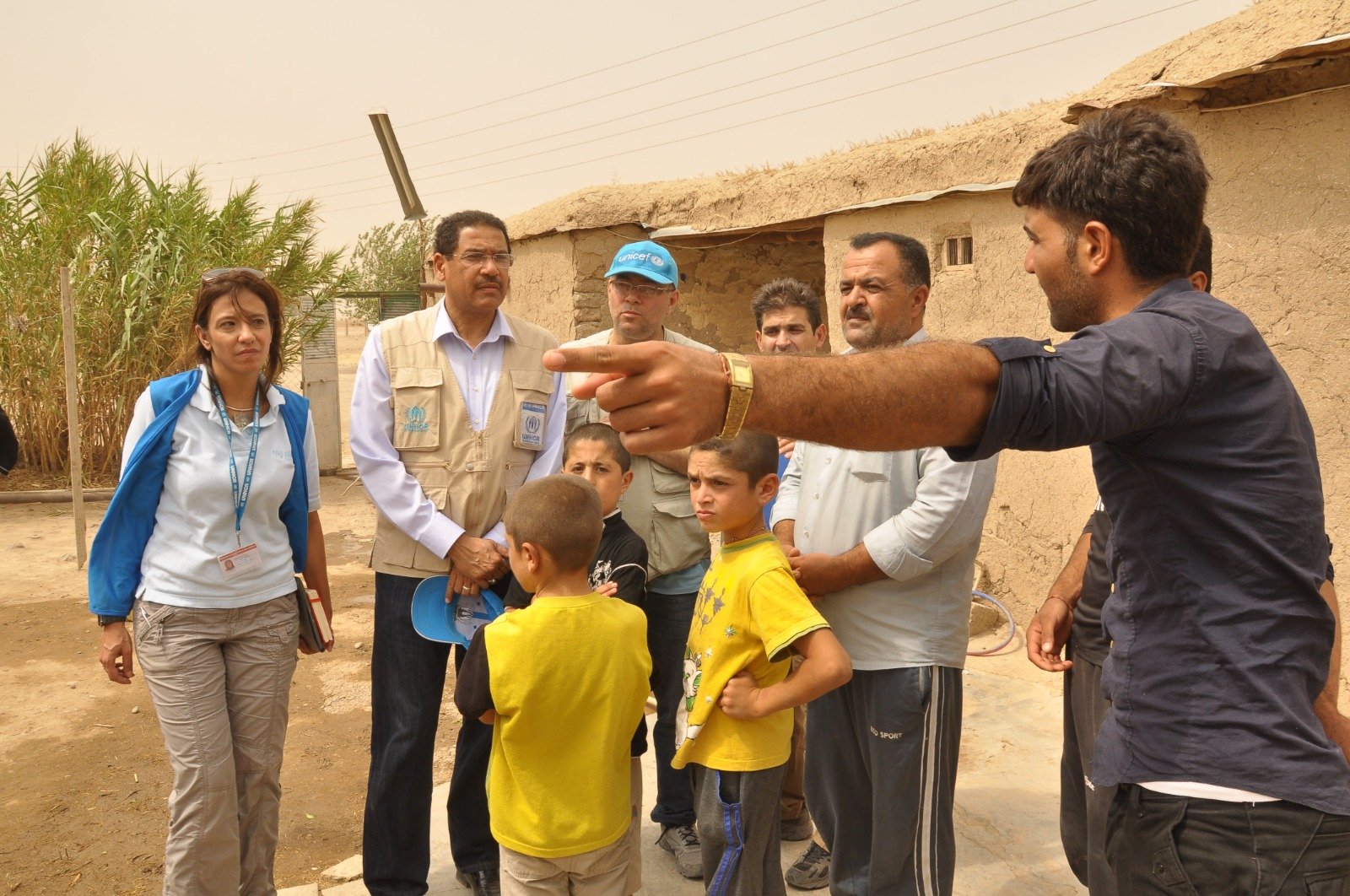 Consulting with community members and children during a village-level field visit.