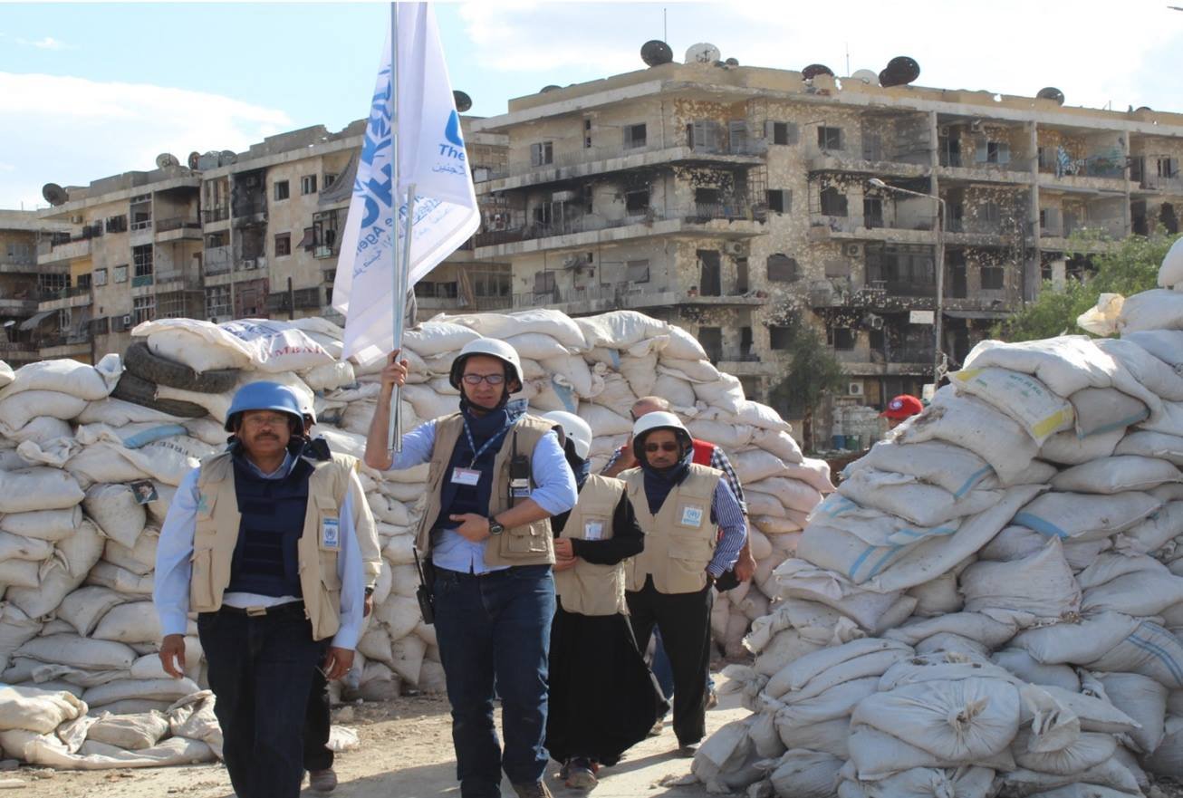 United Nations field mission team moving through a conflict-affected area